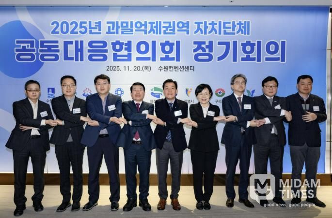 이재준 시장(가운데)과 회의 참석자들이 손을 맞잡고 있다.