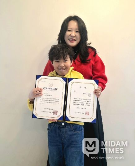 함께하는연구소 박현지 소장(뒤)과 연구소 이용 아동 이건희 군이 「제1회 경북 베리어프리 사생대회」 수상을 기념해 촬영한 모습